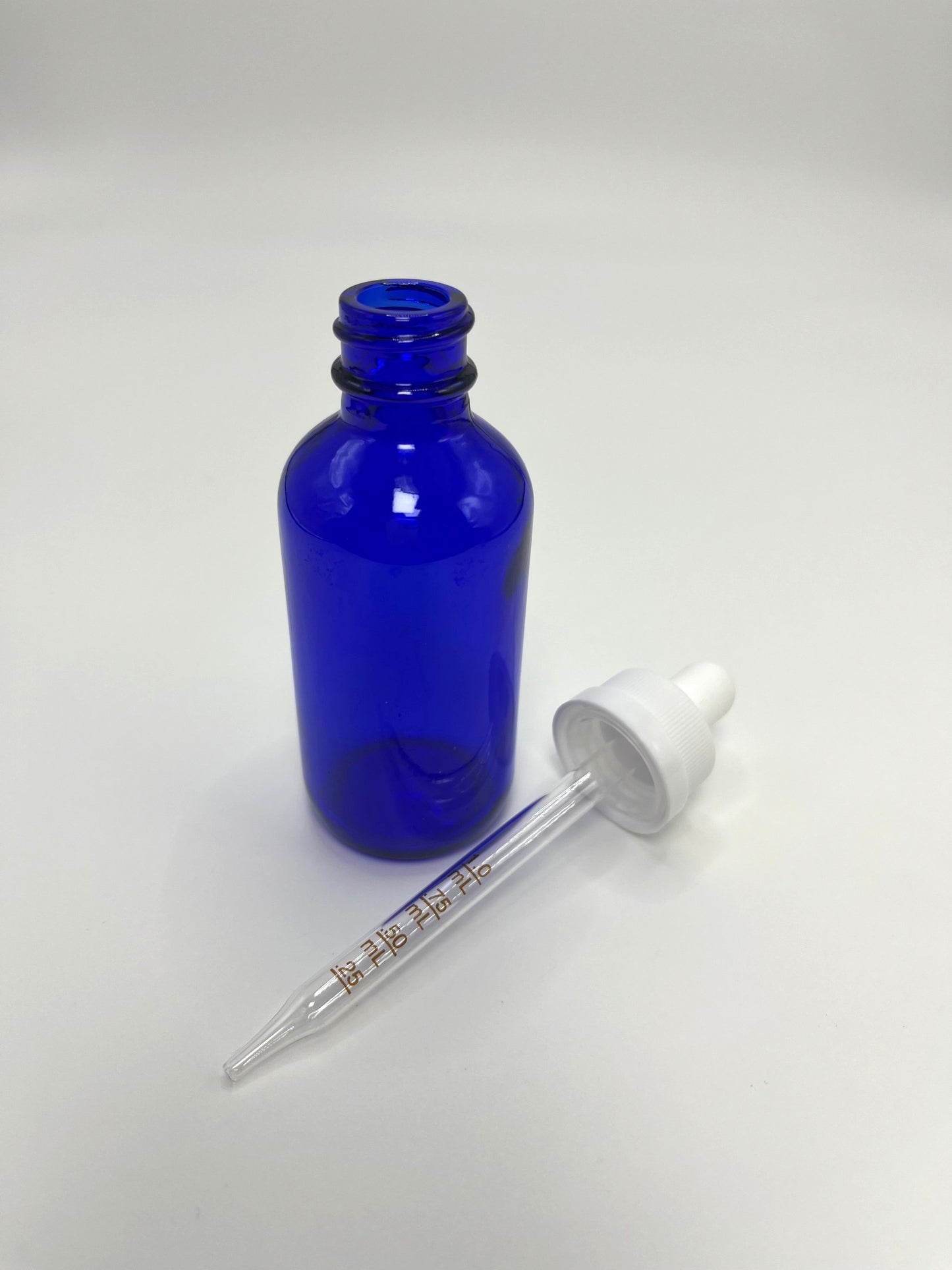 2 oz Cobalt Blue Boston Round Bottle with Graduated CR Glass Dropper