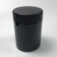 Black opaque glass jar designed to protect cannabis flower from light exposure